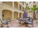 Outdoor courtyard featuring patio dining set, desert landscaping and exterior balconies with a community gathering area at 2555 Hampton Rd # 4204, Henderson, NV 89052