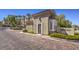 A gated Terra Bella community entrance with a well maintained guardhouse, lush greenery, and paved road at 2555 Hampton Rd # 4204, Henderson, NV 89052