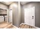 Entryway with view into laundry room with white washer and dryer and faux wood flooring at 2555 Hampton Rd # 4204, Henderson, NV 89052