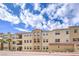 A well-maintained, three-story building boasting multiple balconies, stucco finish, and a classic tile roof at 2555 Hampton Rd # 4204, Henderson, NV 89052