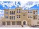 Beautiful building exterior featuring neutral stucco, arches, and a tile roof under a blue sky with clouds at 2555 Hampton Rd # 4204, Henderson, NV 89052