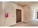 Hallway featuring a brown apartment door, unit 4204, with neutral wall color at 2555 Hampton Rd # 4204, Henderson, NV 89052