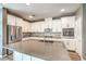Bright kitchen features a large island, stainless appliances, and white cabinets at 2555 Hampton Rd # 4204, Henderson, NV 89052