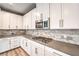Kitchen featuring white cabinets, stainless microwave and a marble subway tile backsplash at 2555 Hampton Rd # 4204, Henderson, NV 89052
