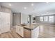 Open-concept kitchen island with stainless steel dishwasher and faux wood flooring at 2555 Hampton Rd # 4204, Henderson, NV 89052