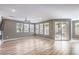 Spacious living room with a ceiling fan, large windows, and faux wood flooring at 2555 Hampton Rd # 4204, Henderson, NV 89052