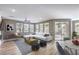 Bright living room featuring a modern sectional sofa, stylish decor, and sliding door access to a patio at 2555 Hampton Rd # 4204, Henderson, NV 89052