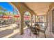 Covered patio features neutral tiling, large support archways, several tables, and abundant seating at 2555 Hampton Rd # 4204, Henderson, NV 89052