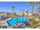 Gorgeous community pool with tables, seating, and palm trees providing a resort-style atmosphere at 2555 Hampton Rd # 4204, Henderson, NV 89052