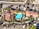 Aerial view of a beautiful community pool surrounded by palm trees, lounge chairs, and well-maintained landscaping at 2555 Hampton Rd # 4204, Henderson, NV 89052