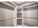 Spacious walk-in closet with custom shelves and wooden rods provides ample storage space at 2555 Hampton Rd # 4204, Henderson, NV 89052