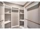 Spacious walk-in closet with custom shelves and wooden rods provides ample storage space at 2555 Hampton Rd # 4204, Henderson, NV 89052