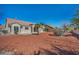 View of home's backyard with stone ground cover, desert landscaping, and block wall at 2628 Showcase Dr, Las Vegas, NV 89134