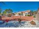 Charming single-story home with desert landscaping and mature trees in the backyard at 2628 Showcase Dr, Las Vegas, NV 89134