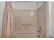Enclosed bathtub and shower area features an updated showerhead and curtain at 2628 Showcase Dr, Las Vegas, NV 89134