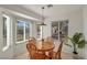 Sunlit breakfast nook featuring a round table, four chairs, and large windows at 2628 Showcase Dr, Las Vegas, NV 89134
