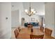 Bright dining room with chandelier adjacent to the spacious living room featuring sliding glass doors at 2628 Showcase Dr, Las Vegas, NV 89134