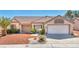 Charming single-story home with a well-maintained front yard and a two-car garage at 2628 Showcase Dr, Las Vegas, NV 89134