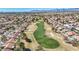 High-angle view of a beautifully maintained golf course surrounded by residences in a vibrant community at 2628 Showcase Dr, Las Vegas, NV 89134