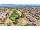 Picturesque aerial view of a golf course winding through a residential community, backed by mountains in the distance at 2628 Showcase Dr, Las Vegas, NV 89134
