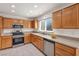 Open kitchen design with tile floors, stainless appliances, and bright natural light at 2628 Showcase Dr, Las Vegas, NV 89134