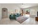 Bright living room with tile floors, comfortable seating, sliding glass doors to the backyard, and neutral decor at 2628 Showcase Dr, Las Vegas, NV 89134