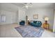 Bright living room featuring tile floors, vaulted ceilings, a comfortable sofa, and ample natural light from the front entrance at 2628 Showcase Dr, Las Vegas, NV 89134