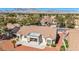 Inviting home featuring a covered patio and desert landscaping, set against a backdrop of mountains and a clear blue sky at 2628 Showcase Dr, Las Vegas, NV 89134