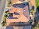 Aerial view of a terracotta-roofed home, mature landscaping, and seating area at 2872 Sumter Valley Cir, Henderson, NV 89052