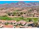 Beautiful aerial shot of a home in a lush golf course community with mountain views at 2872 Sumter Valley Cir, Henderson, NV 89052