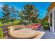Outdoor living with custom patio seating, chairs, and green golf course views beyond the wrought iron fence at 2872 Sumter Valley Cir, Henderson, NV 89052
