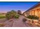 Sprawling backyard with a stone pathway, lush landscaping and verdant golf course views beyond the fence at 2872 Sumter Valley Cir, Henderson, NV 89052
