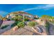 Landscaped backyard with patio seating, desert plants and low maintenance ground cover at 2872 Sumter Valley Cir, Henderson, NV 89052