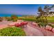 Landscaped backyard with custom patio seating, mature green landscaping and scenic views of the golf course at 2872 Sumter Valley Cir, Henderson, NV 89052