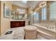 Bright bathroom featuring double sink vanity, step-up soaking tub and glass enclosed shower at 2872 Sumter Valley Cir, Henderson, NV 89052