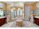 Inviting bathroom with soaking tub, glass shower, vanity, and decorative mirrors and accents at 2872 Sumter Valley Cir, Henderson, NV 89052