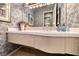 Bathroom featuring floral wallpaper, white vanity, and decorative lighting at 2872 Sumter Valley Cir, Henderson, NV 89052