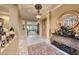 Inviting foyer features an ornate mirror, table, and tiled flooring at 2872 Sumter Valley Cir, Henderson, NV 89052