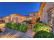 Inviting front entrance with decorative black iron gate and lush landscaping at dusk at 2872 Sumter Valley Cir, Henderson, NV 89052
