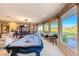 Spacious game room boasts a pool table and large windows with golf course views at 2872 Sumter Valley Cir, Henderson, NV 89052