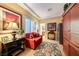 Comfortable living room featuring a plush red sofa and wood furnishings at 2872 Sumter Valley Cir, Henderson, NV 89052