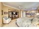 Serene main bedroom with sitting area and custom entertainment center at 2872 Sumter Valley Cir, Henderson, NV 89052