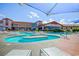 Resort-style pool area with ample seating and sun umbrellas and views of the building at 2872 Sumter Valley Cir, Henderson, NV 89052