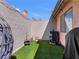 Small private backyard featuring artificial turf and patio area at 321 Yardarm Way, Las Vegas, NV 89145