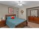 Cozy bedroom featuring a ceiling fan, dark wood furniture, and a mirror at 321 Yardarm Way, Las Vegas, NV 89145