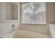 Close-up of tiled bathtub with window and natural light at 3417 Steppe St, North Las Vegas, NV 89032