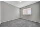 Bedroom with grey walls, grey carpet, and a window at 3417 Steppe St, North Las Vegas, NV 89032