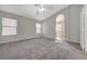 Carpeted main bedroom featuring two windows, an archway, and neutral gray tones at 3417 Steppe St, North Las Vegas, NV 89032