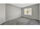 Bedroom with neutral walls, carpet and a window bringing in natural light at 3417 Steppe St, North Las Vegas, NV 89032