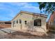Rear exterior featuring a stucco wall, concrete patio, rock landscaping, and multiple windows at 3417 Steppe St, North Las Vegas, NV 89032